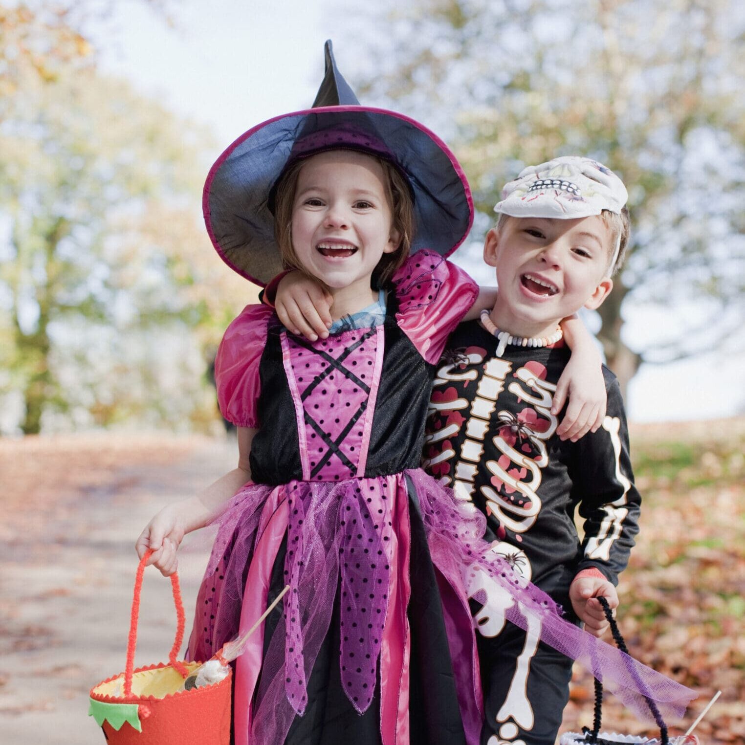 Laughing children in Halloween costumes